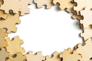 blank empty white space with scattered wooden jigsaw puzzle as frame. empty space for copy spaces.