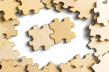 wooden puzzle pieces with scattered jigsaw puzzle as frame. empty space for copy spaces.