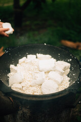 the cheese is boiled in a large cauldron