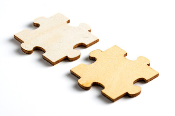 wooden jigsaw puzzle pieces isolated on white background.
