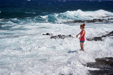 Happy woman enjoying the waves