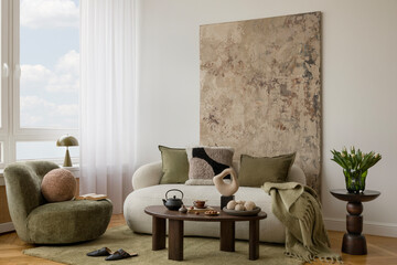 Elegant neutral living room with white sofa, olive green pillow, yellow spring flowers in a vase...