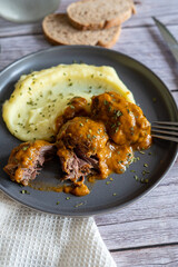 homemade recipe of pork cheeks with gravy and mashed potatoes