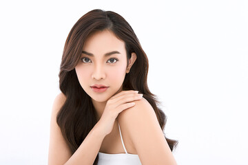 Fototapeta premium A beautiful young Asian woman with clean, fresh skin against a white background. Skincare, facial treatment, cosmetology, beauty, and spa. An elegant portrait of an Asian woman.