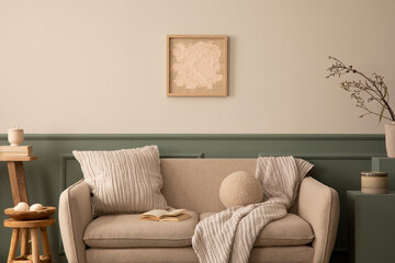Cozy composition of living room interior with mock up poster frame, beige sofa, wooden stool, beige...