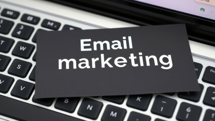 Digital communication strategy featuring black card resting on laptop keyboard highlighting email marketing message