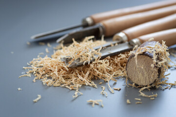 Hand tool and shavings after wood carving