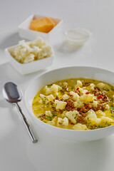bacon cheeseburger soup with cauliflower in a cheesy beef stock