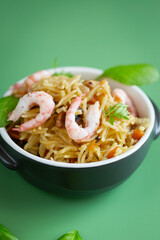 Homemade ceramic dish with vegetable rice and shrimps