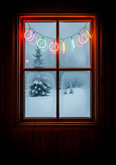 Fototapeta premium Cozy Winter Window with Colorful Neon Ring Lights Overlooking Snowy Forest Landscape Scene