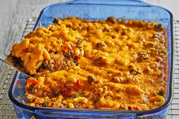 bulldog casserole made with macaroni pasta, ground beef, cheddar cheese, and tomato salsa