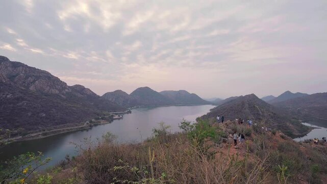 Tourists explore Bahubali Hills in Udaipur with a stunning view of Badi Lake, highlighting peaceful nature, travel, and scenic landscapes in Rajasthan