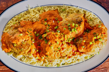 chicken paprikash on a bed of homemade spätzle