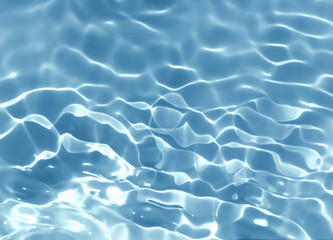 Abstract blurred shades of blue water background. Light and shadow ripples or splashes surface of water texture. Water waves with shining and reflection pattern photography for​ design artwork.