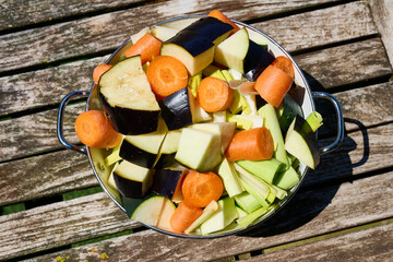 Freshly chopped vegetables in a bowl on rustic table