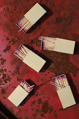 matchbox on red old iron background. matches with pink sulfur