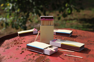 matchbox on red old iron background. matches with pink sulfur