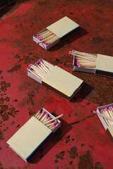 matchbox on red old iron background. matches with pink sulfur