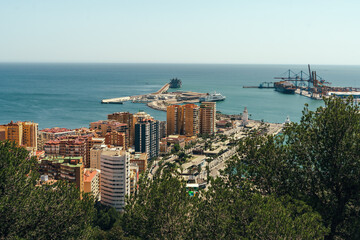 Coastal cityscape with vibrant buildings, tranquil sea, and bustling harbor.