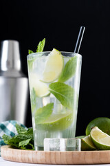 Classic Mojito Cocktail with Lime and Mint on black background