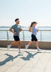 Joyful morning joggers along the waterfront trail under a clear blue sky