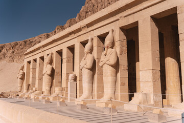 Majestic osirian statues guarding hatshepsut temple in luxor, egypt