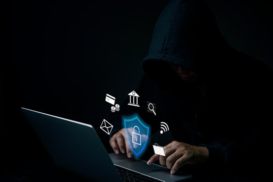 Cybersecurity concept, data protection, digital security. Hacker working Finance, banking and investment laptop, dark background. Cybercrime, online fraud, internet safety.Privacy breach Network.