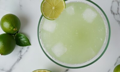 Refreshing margarita cocktail with lime and ice on marble surface close up