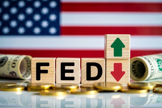 US federal reserve concept with fed blocks, arrows, dollar bills and coins in front of American flag.