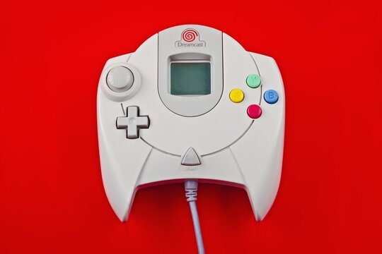 Neu-Ulm, bavaria, Germany - July,  08, 2025:  SEGA Dreamcast controller isolated on red background.	