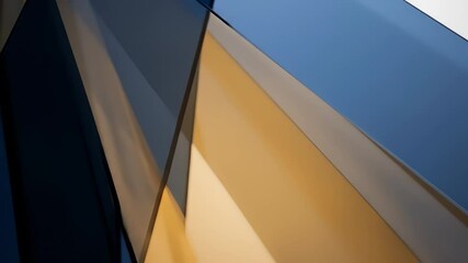 Dynamic abstract geometric glass shapes with shifting blue and golden light reflections.