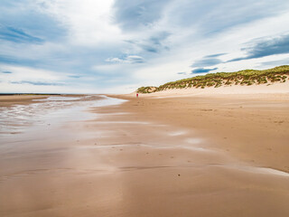 One person on the beach in the distance, Northumberland Coast