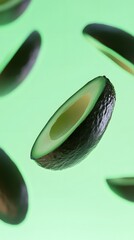 Avocado halves levitating against a pale green background.