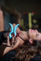 Woman using blue clitoral vibrator. 