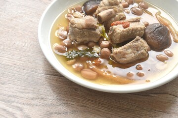 boiled chop pork bone with peanut and black mushroom soup on plate