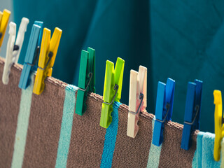 The colorful pegs on the clothes drying on the line