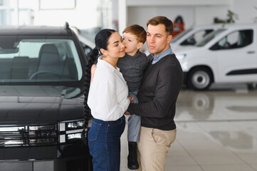 family choosing a car in dealership, they want the most comfortable and safe car