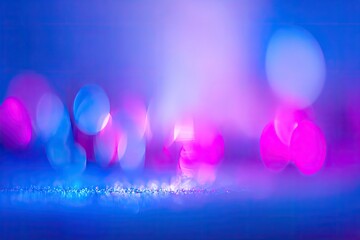 Abstract bokeh display of vibrant blue and pink lights