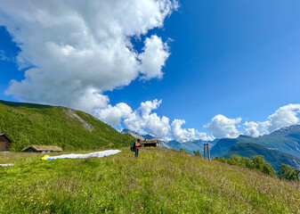 A person ready to take off with a paraglider. with beautiful mountain and fjord scenery in the...