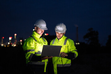 Engineer worker watching work monitor on laptop and checking for quality control at construction...