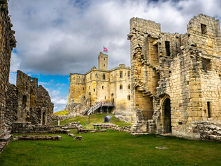 Fototapeta premium Main keep of Warkworth Castle, Northumberland, UK with cloudy sky