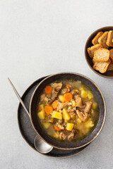 Oyster mushroom soup in plates, soup made from Pleurotus mushrooms and potatoes, carrots and spices, top view, copy space