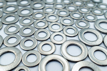 Set of metal washers in the foreground, steel ring circle, metal shining washers background — essential for distributing load in mechanical assemblies, ideal for construction and industrial design pro