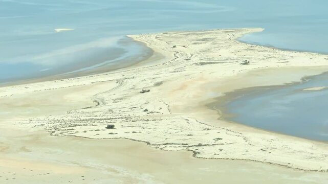 An aerial view of Lake Eyre in South Australia. This unique footage captures the vast, arid basin transforming as water rarely fills its expanses, showcasing Australia's dynamic outback.