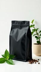 Minimal black coffee bag with green herbal accent on white background, trendy, white