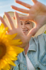 A Joyful Woman holding a radiant Sunflower in a Bright Sunny Field full of life