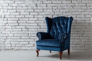 Blue velvet armchair with tufted back against white brick wall wooden floor