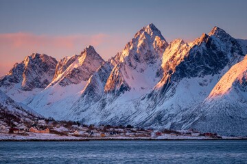 Snowcovered mountains  a small village line a shore bathed in warm light at dawndusk