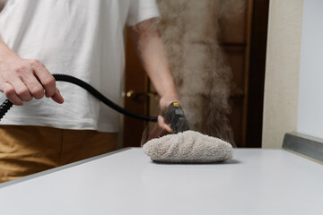 Process using steam cleaner, sanitizing kitchen countertop with modern housekeeping appliance,...
