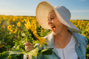 A Joyful Woman Delightfully Enjoying Sunflowers in a Beautiful and Vibrant Field of Nature